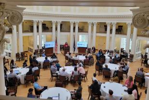 Image of group around tables in UVA Dome Room during Day 1 of event