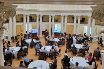 Image of group around tables in UVA Dome Room during Day 1 of event