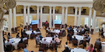 Image of group around tables in UVA Dome Room during Day 1 of event