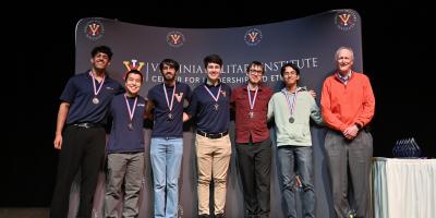 group of cyber defense team in front of banner